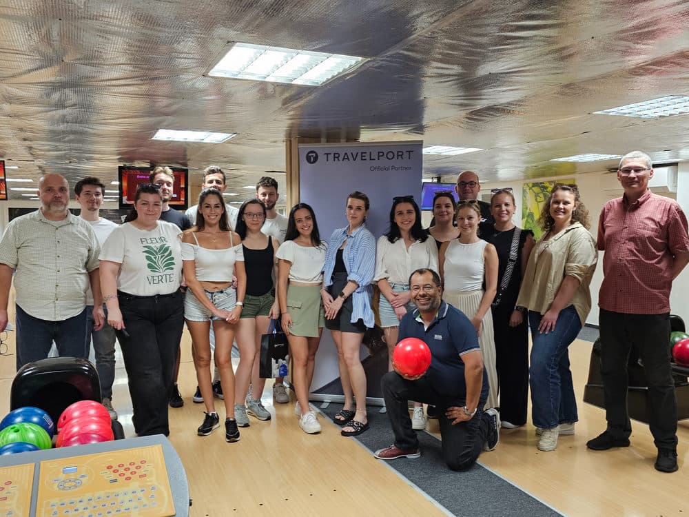 Účastníci bowlingového setkání ve Zvolenu s bannerem Travelport